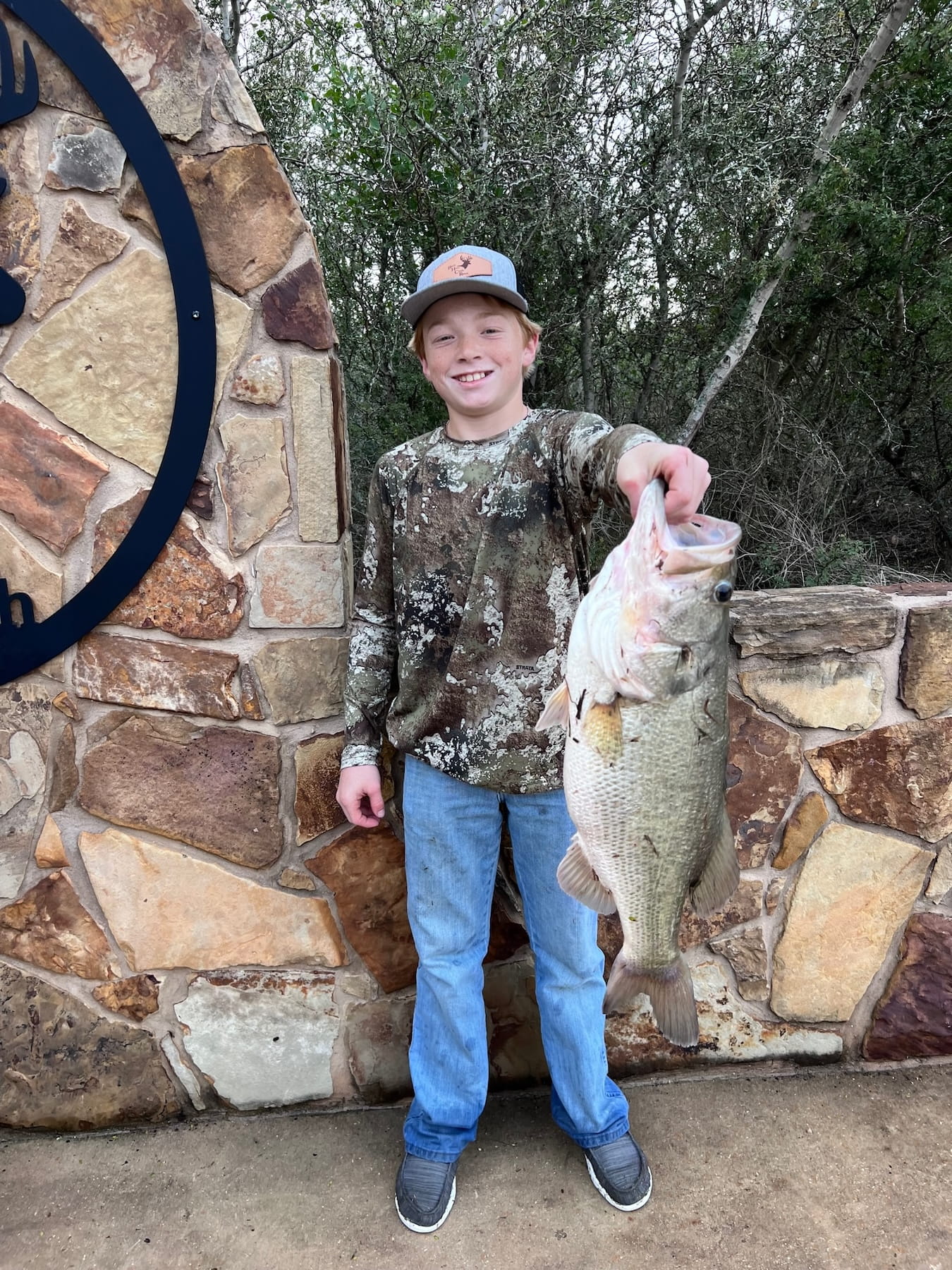 young boy posing with caught fish
