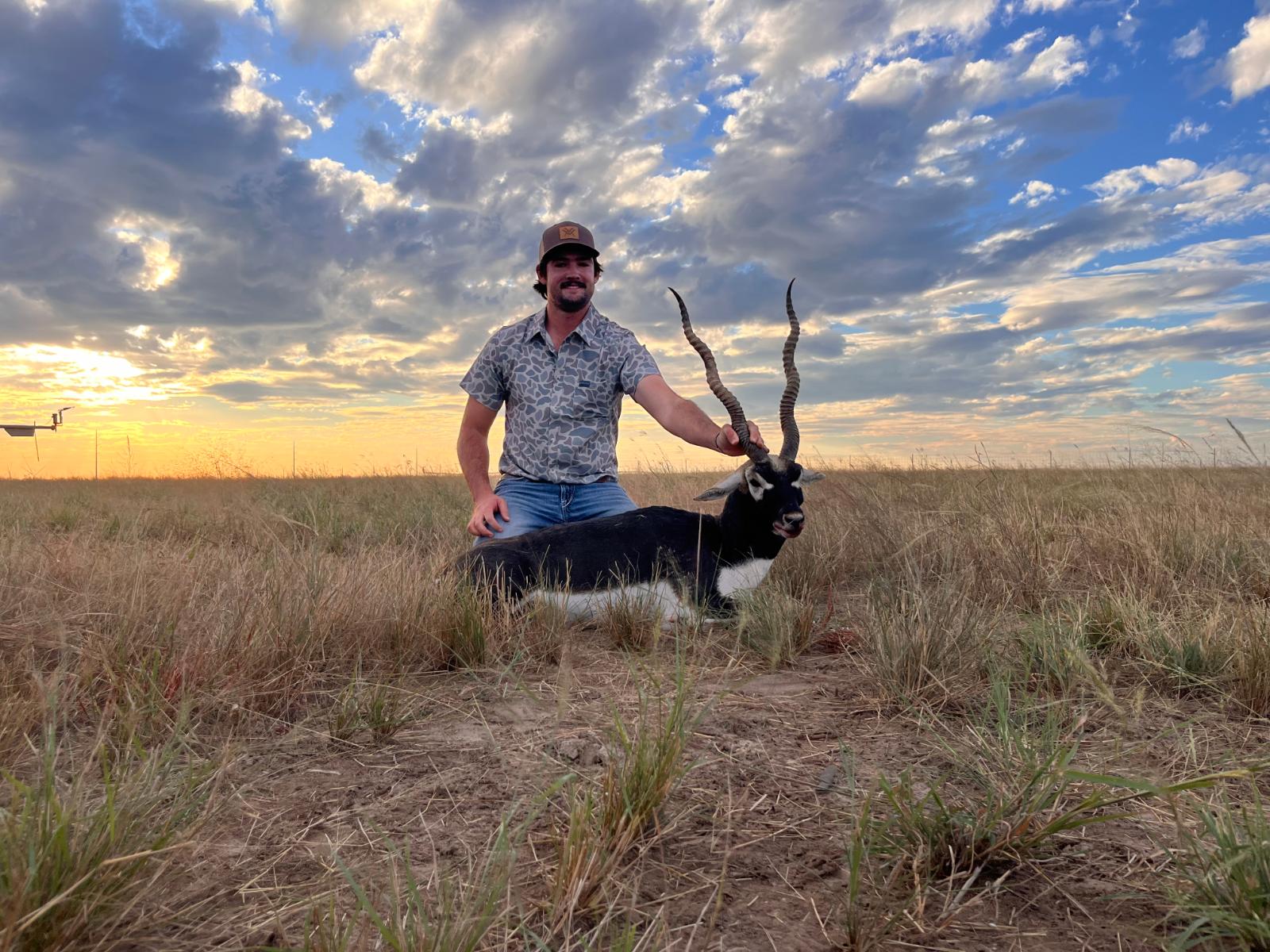 A man posing with a hunted exotic