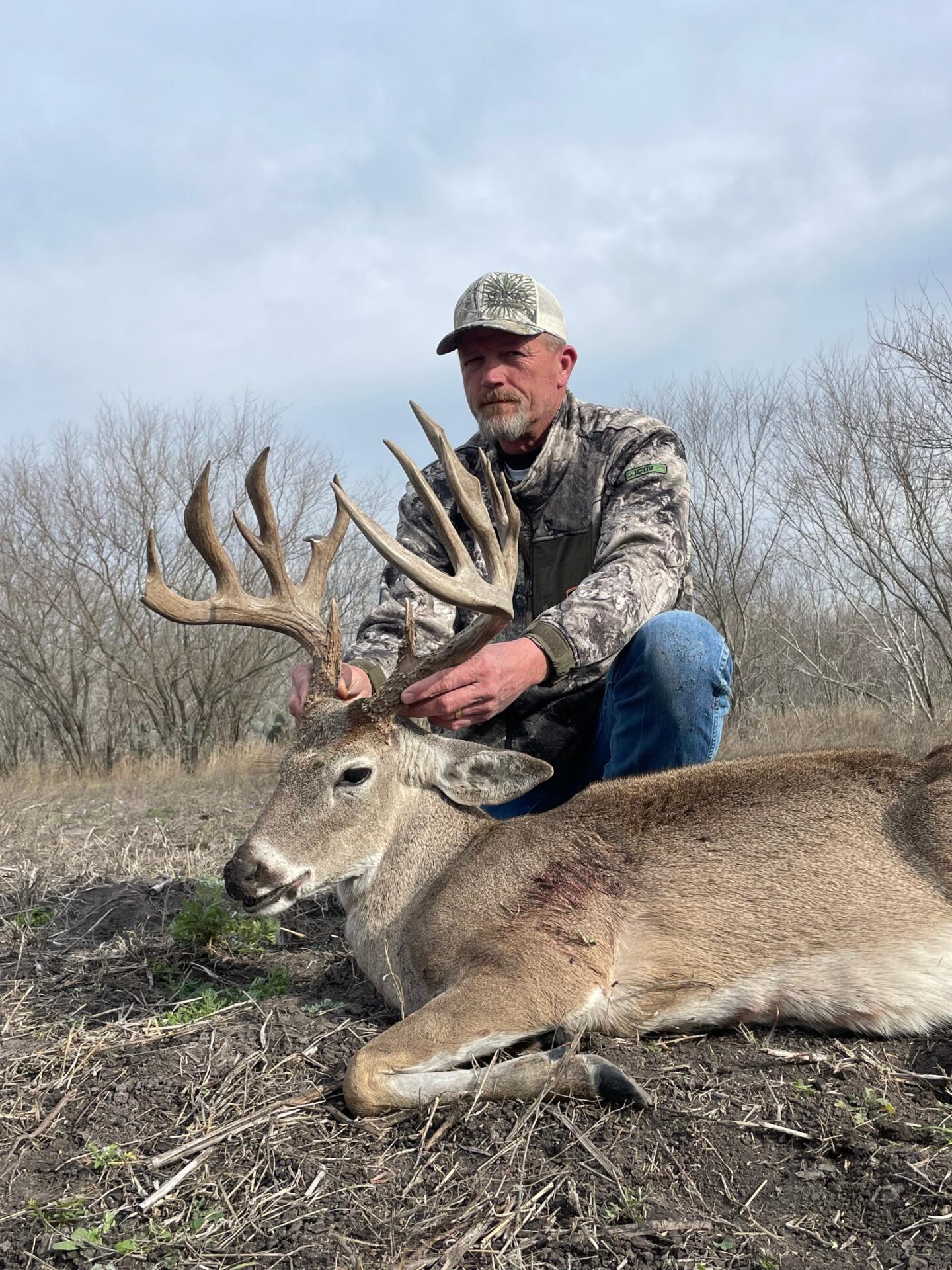 Man posing with hunted buck