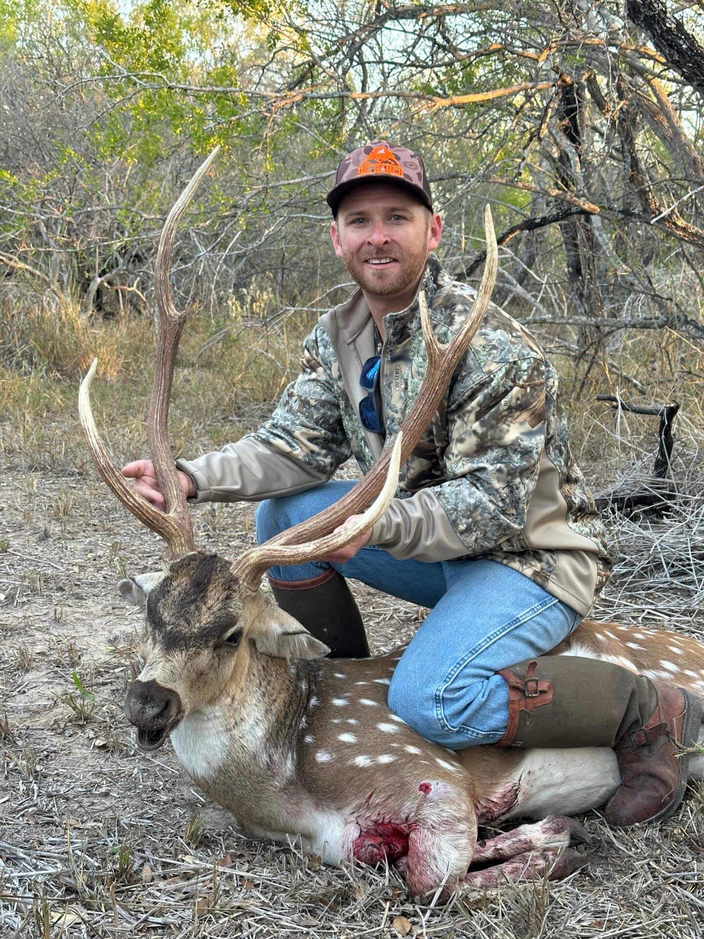 Man posing with hunted buck