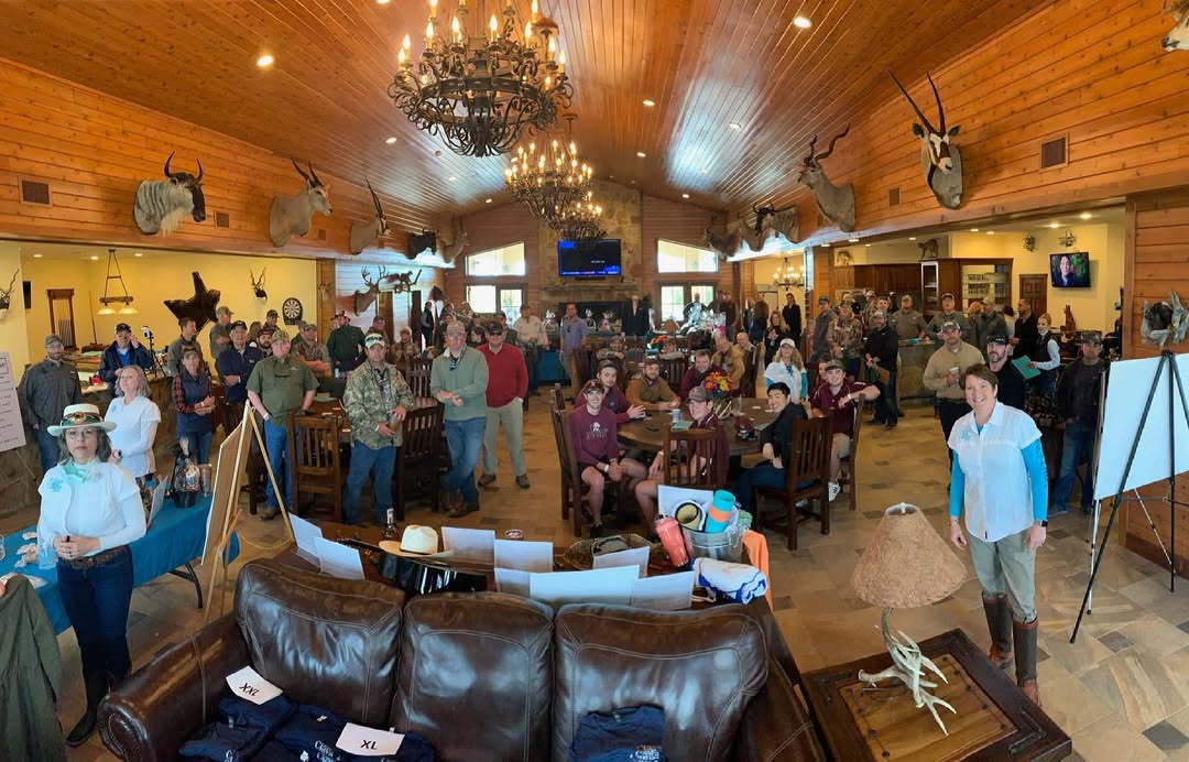 large crowd gathers at dining tables in the lodge