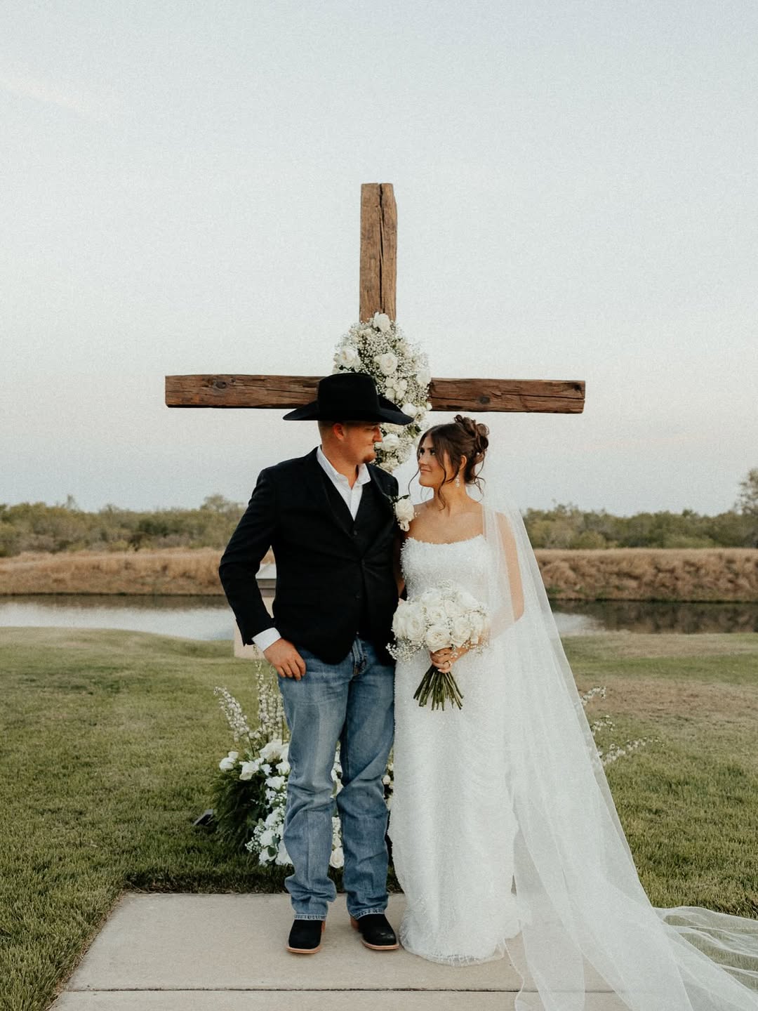 a bridge and groom posing at the wedding altar of an outdoor ceremony