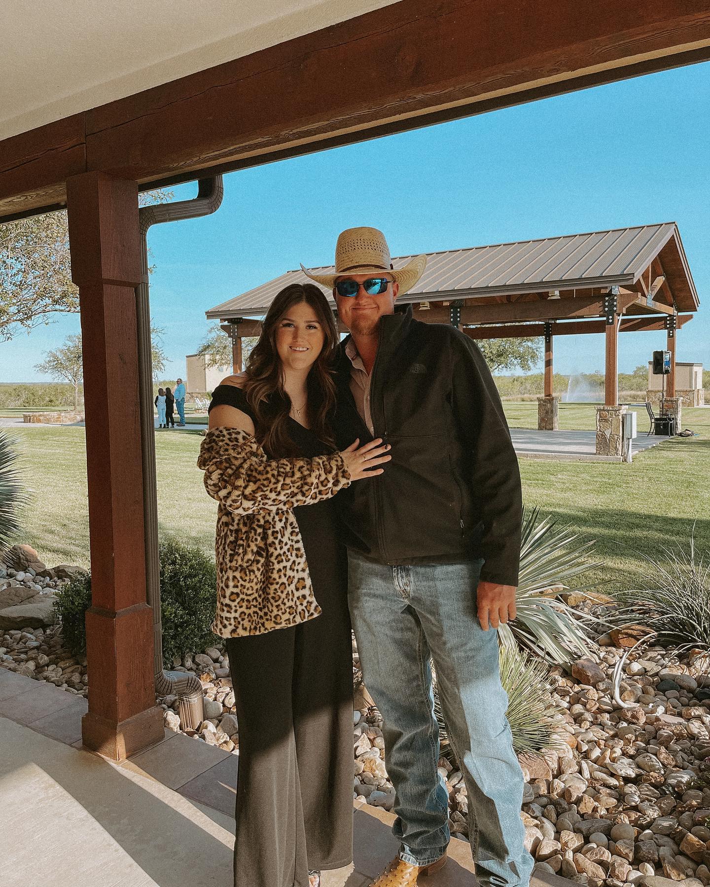 a couple attending a wedding stading under a patio overhang